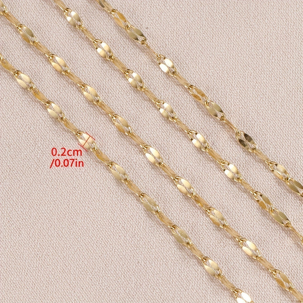 Gold chain with a measurement label on a beige background